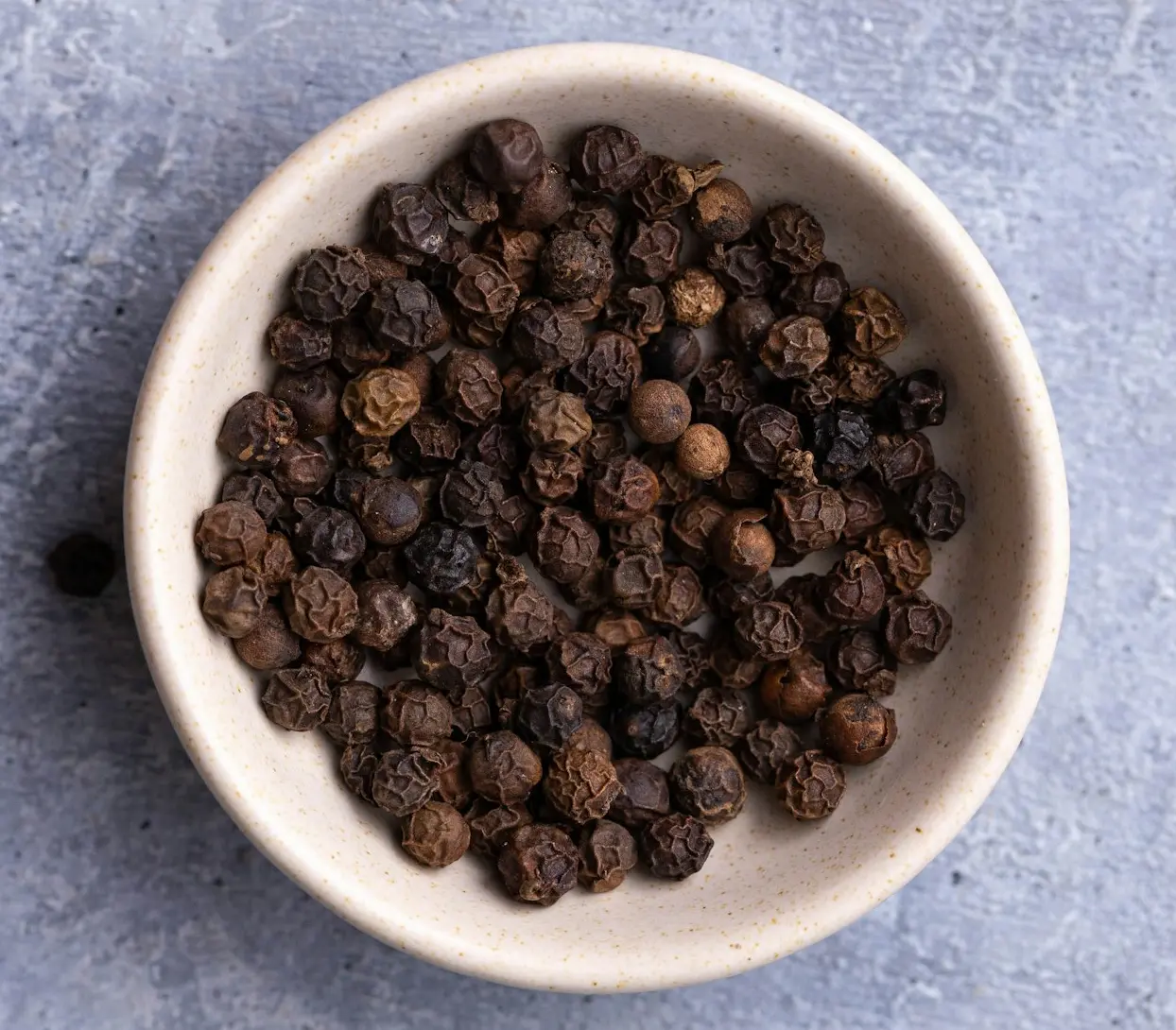 brown coffee beans on white ceramic bowl